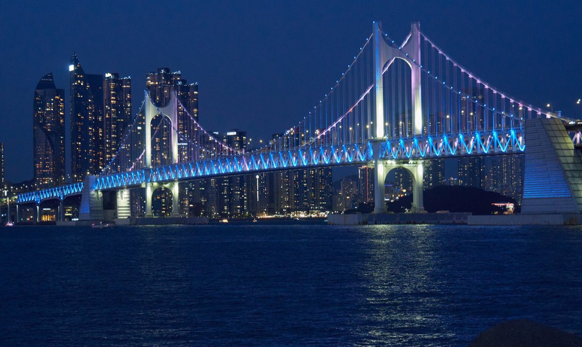 The Gwangan Bridge lit up at night over Gwangalli Beach