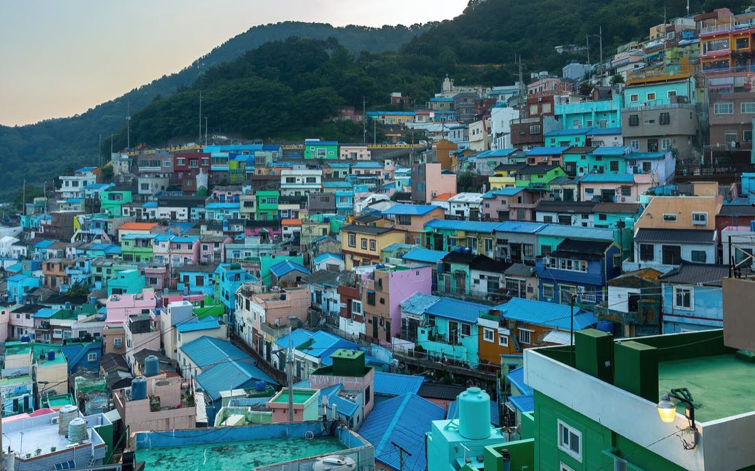 The stacked pastel houses of Gamcheon Culture Village at sunset