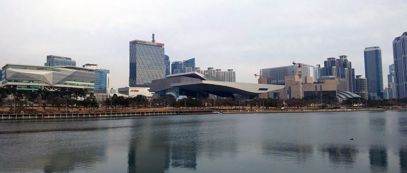 Centum City on the water, with the Busan Cinema Center roof at dusk