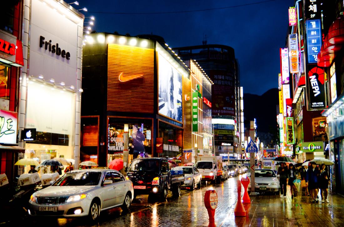 Neon signs over a rainy shopping street in Seomyeon, Busan