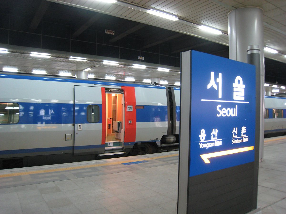 A KTX train beside the Seoul Station platform sign