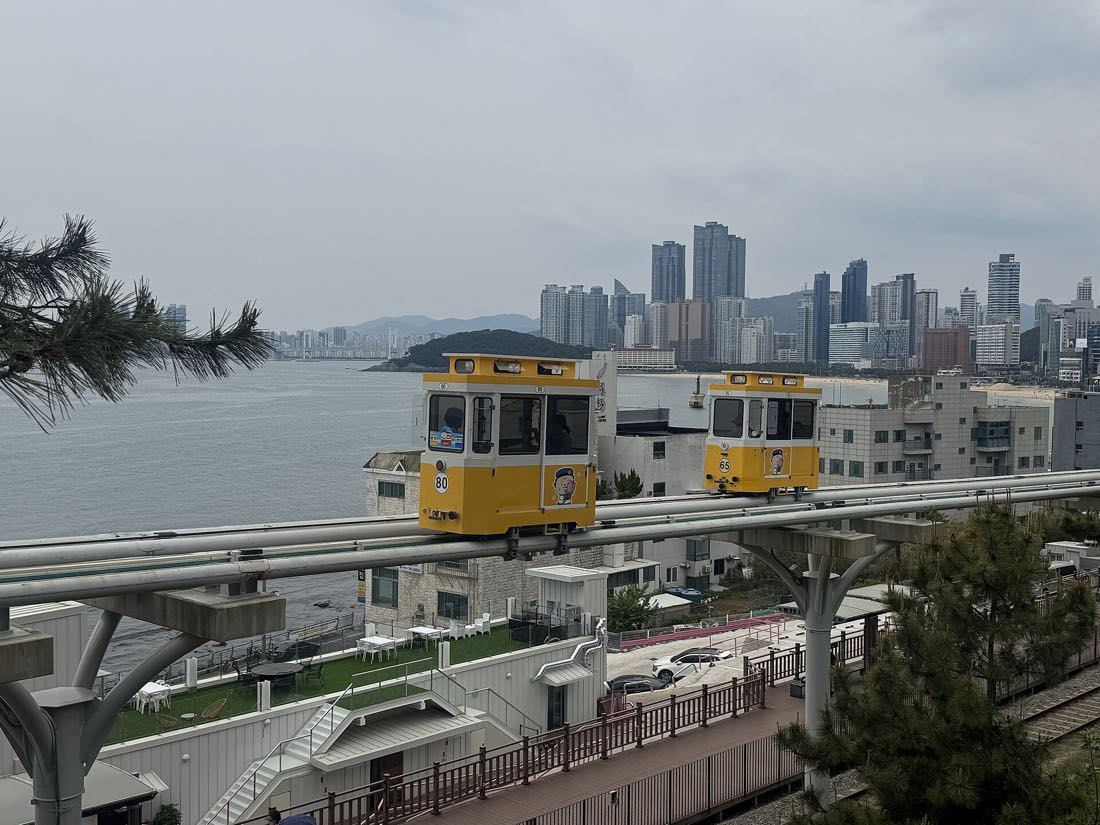 A Sky Capsule car on the elevated Blueline Park track above the Haeundae coast